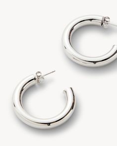 There’s a reason we’ve aptly named these silver hoops. Because they’re ultra-lightweight, they practically float. Measuring at 1” in diameter and 4.5mm thick, these silver hoops are made from recycled brass and rhodium plating. They are designed to be an evergreen staple in your repertoire. And, it’s a good thing they’re made to last, because silver hoops match pretty much anything! Wear them on their own for a simple, understated look, or layer multiple earrings for a more curated style. Handmade: Our gold and silver hoops are handmade with care to ensure the best quality jewelry. These hoops are handmade with recycled brass and sterling Silver and Rhodium plated. Understated Simplicity: Nothing is more elegant than a simple gold or silver hoop. It adds an elevated touch to your outfit, n Polished Metal Hoop Huggie Earrings, Silver Sterling Silver Tarnish-resistant Hoop Earrings, Shiny Metal Hoop Jewelry, Silver Sterling Silver Hoop Earrings Tarnish Resistant, Silver Tarnish-resistant Sterling Silver Hoop Earrings, Hoop Metal Jewelry With Polished Finish, Small Hoop Metal Jewelry With Shiny Finish, Polished Metal Hoop Jewelry, Small Hoop Silver Earrings Tarnish Resistant