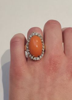 Vintage 14k Diamond Orange Coral Halo Cocktail Ring Total Size: 27.47 x 18.03 mm Coral Size: 21 x 13.48 mm 22 small diamonds Diamonds Total 0.75 Carate Ring Size: US 6 Weight 14.9 grams Formal Orange Diamond Ring, Orange Diamond Ring As Gift, Orange Diamond Ring As A Gift, Orange Diamond Jewelry With Diamond Accents, Orange Diamond Ring With Prong Setting, Oval Cabochon Diamond Ring For Gift, Oval Cabochon Diamond Ring As Gift, Orange Diamond Rings With Prong Setting, Classic Orange Diamond Ring