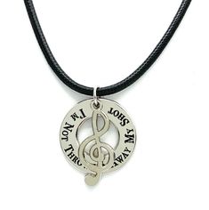 a necklace with a treble on it that says i am not afraid to sing