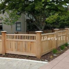 a wooden fence with the word prowl written on it in front of a house