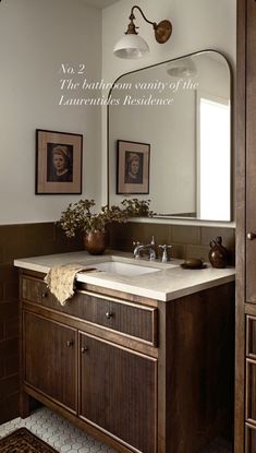 a bathroom sink sitting under a large mirror next to a wooden cabinet and counter top