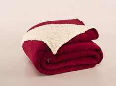 a red and white blanket folded on top of each other