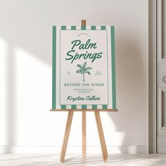 an easel with a palm springs sign on it in front of a white wall