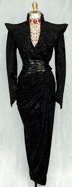 a mannequin is dressed in black and gold