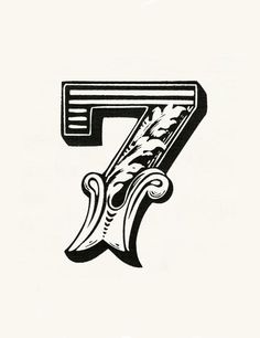 the letter f is decorated with flowers and leaves in black on a white paper background