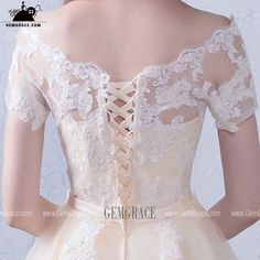 the back of a woman's dress with lace detailing