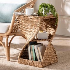 a wicker table with books and cups on it next to a chair in a living room