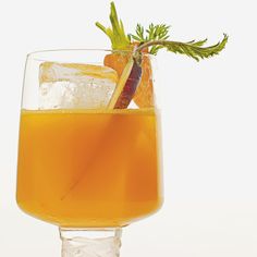 a glass filled with orange juice and garnish