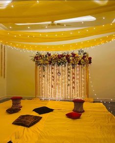 a decorated room with yellow drapes and flowers