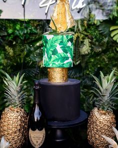 there is a cake with pineapples on it and a bottle of wine next to it