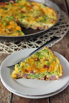 a slice of ham and broccoli quiche on a plate with a fork