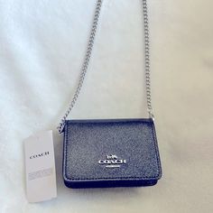 Nwt Coach Cp249 Mini Wallet On A Chain In Color Silver/Gunmetal So Cute, Chick & Petite! Currently Sold Out Online! Glitter Patent Leather With Interior Fabric Lining. Exterior Open Pocket On Back, 2 Interior Card Slots & Snap Button Closure. Detachable Chain Strap W/ 23.25” Drop For Shoulder Or Crossbody Wear! Neutral & Versatile! Includes Original Tags & Care Instructions. Measures Approximately 4” X 3” X 1”. So Pretty & Collectible! Friendly Seller, Fast Shipping, Smoke Free & Pet Free Home Coach Silver Bag With Gunmetal Hardware, Chic Coach Black Wallet On Chain, Coach Shoulder Bag With Silver-tone Hardware For Daily Use, Coach Mini Purse, Pink Coach Purses, Coach Crossbody Satchel With Silver-tone Hardware, Purple Y2k, Black Coach Bag With Silver-tone Hardware, Leather Cosmetic Bag