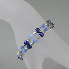 "This blue double strand bracelet is handmade using fresh water pearls and cateye. Free US shipping. Customers who purchased this item said: \" I bought these bracelets along with the matching earrings for my bridesmaids and couldn't have been happier. They are great quality for the price and looked perfect on my navy-clad bridesmaids.: Blue is the most popular color among men and women. It is universally appealing. Blue suggests the depth of personality and reserves of integrity, authority, pos Bridesmaids Blue, Crochet Beaded Bracelets, Turquoise Hoop Earrings, Bracelet And Necklace, Etsy Bridesmaid Gifts, Bracelets Handmade Beaded, Strand Bracelet, Matching Necklaces, Bridesmaid Gift