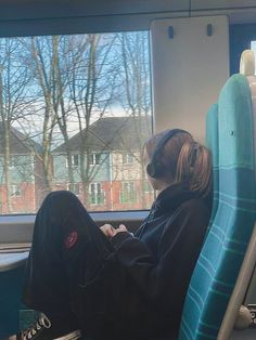 a person sitting on a train looking out the window