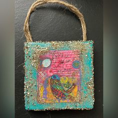 a small bag that has been decorated with some kind of bird on it's side