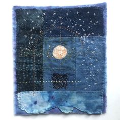 a patchwork piece with stars and moon in the sky on it's side