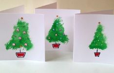 three handmade christmas cards with trees on them, one is green and the other is red