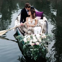 a bride and groom in a boat on the water