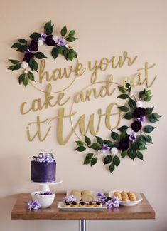 a table topped with cakes and desserts next to a wall