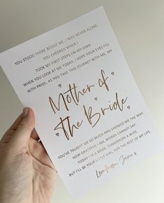 a person holding up a card with the words mother of the bride written on it