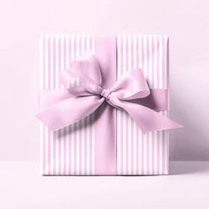 a pink gift box with a bow on it