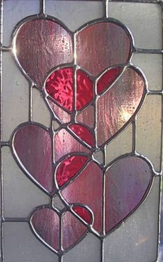 a stained glass window with hearts on it