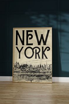 a poster with the words new york on it in front of a blue wall and wooden floor