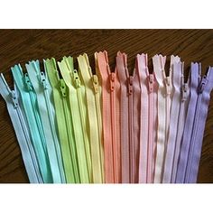 several colors of zippers on a wooden table