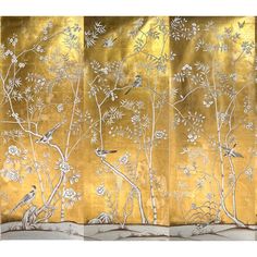 three panels with birds and flowers painted on them, each panel has an intricate gold background