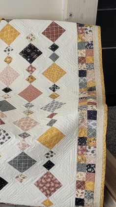 an old quilt is laying on the floor