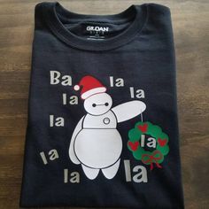 a black t - shirt with a white bear wearing a santa hat and holding a candy cane