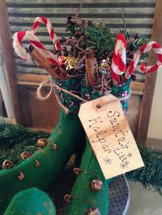 an old pair of green boots with christmas decorations in them and a price tag attached to the boot