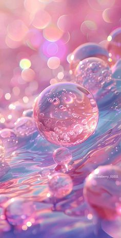 some bubbles floating in the water on a pink and blue surface with bright lights behind them