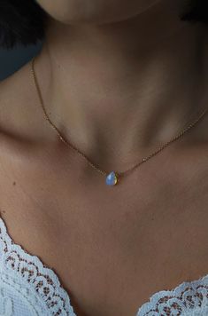 Lune. Such beauty and magic in the most subtle way. Iridescent tiny drop that catch the light give a magical vibe to She who wears this piece. This necklace is composed of 14K gold vermeil delicate chain and tiny opalite drop. It also makes a gorgeous gift for moonstone lovers!  Personalize your own magical piece: ❉ 14K Yellow Gold vermeil ❉ 14K Rose Gold vermeil ❉ 925 Sterling Silver You can choose between 2 chain lengths: 16 / 18 inches Not sure which length to buy? We can add a 1 inch extender chain. Just write a note at checkout! ❈ We send all our items with registered mail. ❉ Due to the organic nature of stones, there might be a slight variation in colour, size and shape. ✺ All items come packaged in a quality velvet pouch ready for gift giving. ✽ If you want to make a special order, Dainty Teardrop Opal Necklace, Delicate Moonstone Necklace With Delicate Chain, Dainty Opal Pendant Necklace, Dainty Opal Adjustable Necklace, Opalite Necklace Pendants, Opalite Necklace, Dainty Gold Necklace, Gorgeous Gift, Wedding Jewellery Necklace