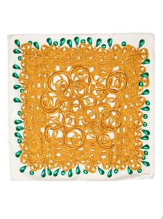 an orange and green doily on a white surface with small circles in the center