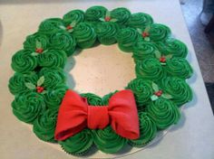 cupcakes take the cake with red bows on top and green frosting in the middle