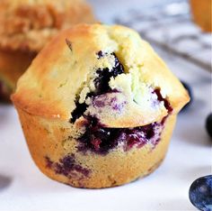 blueberry muffins sitting on top of a white table