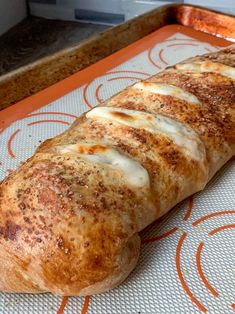 a close up of a bread on a tray with the words bbq chicken stromboli