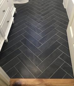 a bathroom with black and white tile flooring