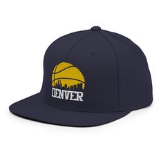 "Made of a premium wool blend with a high-profile, flat bill design, this Denver basketball snapback cap is sure to be a winner with loyal followers of Nugget basketball and anyone who is from the 312 -- Denver, CO. Features a retro Denver basketball design with a silhouette of the city skyline. A unique and nostalgic option for the Denver basketball fan, this adjustable snapback Nuggets hat is a cool and stylish gift for a birthday, holiday or Nuggets game. * High-profile, structured 6-panel De Retro Snapback Hat With Curved Bill For Sports, Collegiate Snapback Hat With Curved Bill, Vintage Snapback Hat With Curved Bill For Sports, Collegiate Six-panel Snapback Hat For Fan Gear, Nba Snapback Hats, Basketball Design, Basketball Fans, Embroidered Baseball Caps, Colour Star