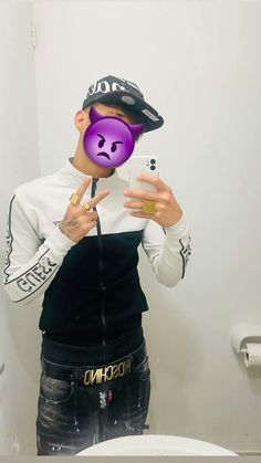 a person taking a selfie in front of a mirror with a purple mask on