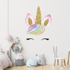 a child's room with a unicorn wall decal in the shape of a head