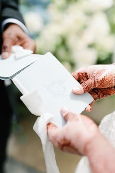 the bride and groom are exchanging their wedding vows