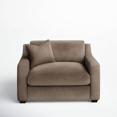 a couch with pillows on it in front of a white wall