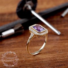 "(Please confirm your US size when you make an order) Jewelry Details -Gold Type : 14k gold Center Stone: NATURAL Amethyst 5.5*8mm, Approximately 1.5ct Color: 3A Clarity: VS Cut: Emerald Cut / 3EX Side Stone: 0.14cttw diamond Color: G-H Clarity: SI1 Cut: Round Cut / 3EX Band Width: Approximately 1.8mm SKU: YR0142 ~*-*~Purchase Guarantee: - All our jewelry is handmade, and each process is refined. - 14 Day Refund Guarantee. - All our products are Free Shipping. - Free Gift Box&Packing. ~*-*~P Heirloom Purple Sapphire Ring For Anniversary, 14k Gold Art Deco Amethyst Ring, 14k Gold Amethyst Ring In Art Deco Style, 14k Gold Amethyst Ring Art Deco Style, Amethyst Anniversary Ring With Halo Setting In Yellow Gold, Heirloom Style Purple Amethyst Ring With Bezel Setting, Heirloom Purple Amethyst Ring With Bezel Setting, Green Tourmaline Engagement Ring, Gold Art Deco Ring