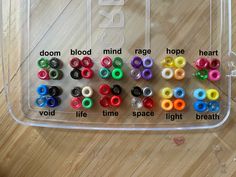 a plastic container filled with lots of different colored beads