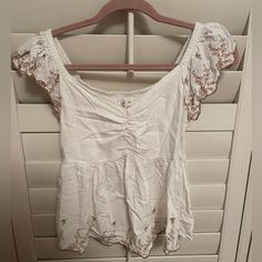 This Top Is The Perfect White Top- It Isn’t See Through At All! It Is Basically Brand New- Not Sure On Where The Brand Is From Maybe Tj Maxx? Sleeveless Embroidered Tops For Brunch, Summer White Embroidered Top, White Embroidered Summer Top, Floral Embroidered Short Sleeve Tops For Brunch, White Embroidered Top For Summer Brunch, Embroidered White Summer Top, Summer Embroidered Top With Flutter Sleeves, Summer Flutter Sleeve Embroidered Top, Fitted Summer Embroidered Top With Ruffles