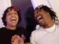 two young men laughing together with hello kitty ears on their head and one holding his hand out