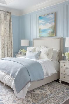 a bedroom with blue walls and white furniture