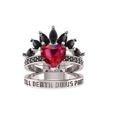 a heart shaped ring with black and white stones on it, surrounded by an inscription that says